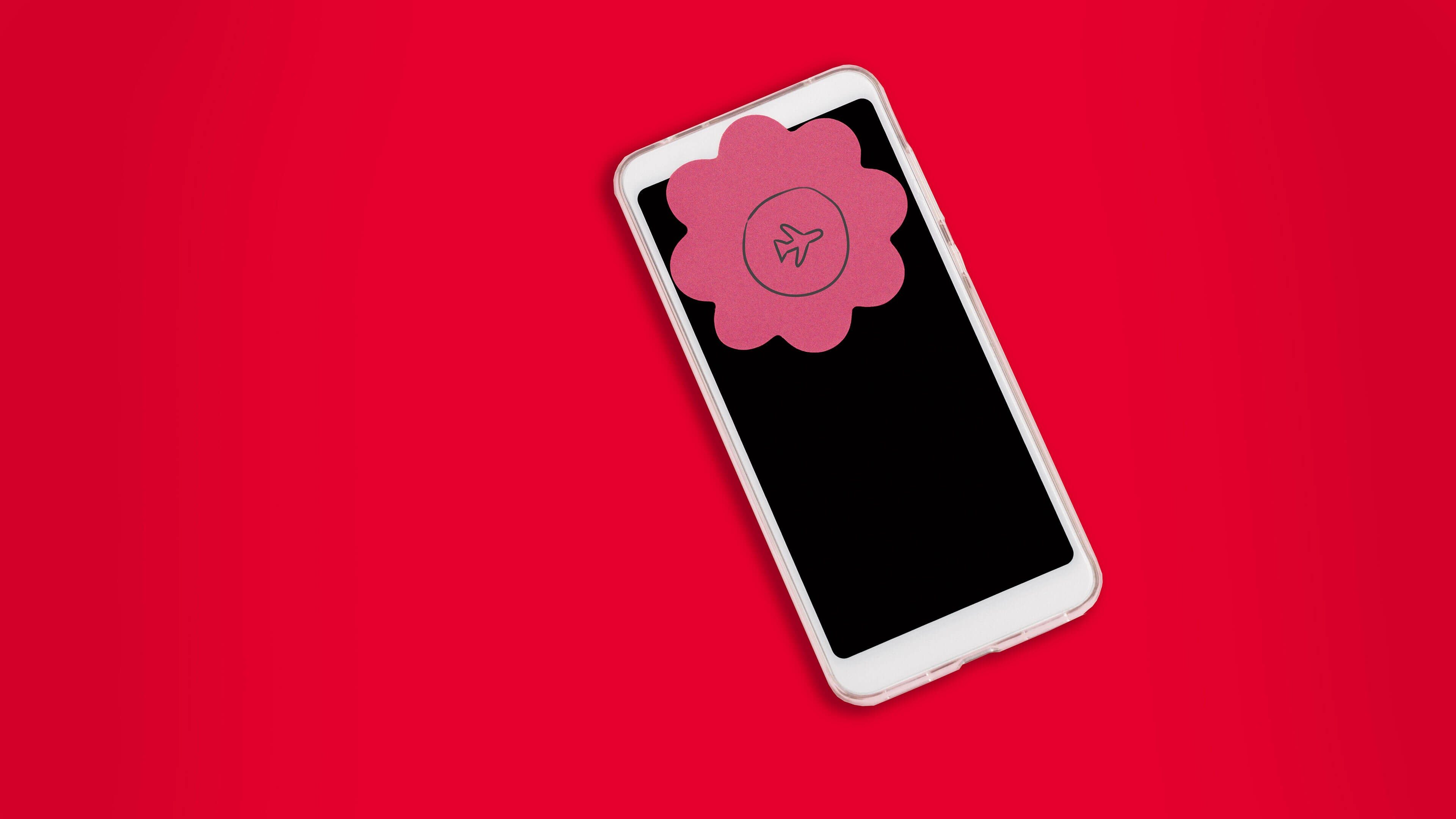 Handy auf roten Hintergrund mit Tipps für digital Detox