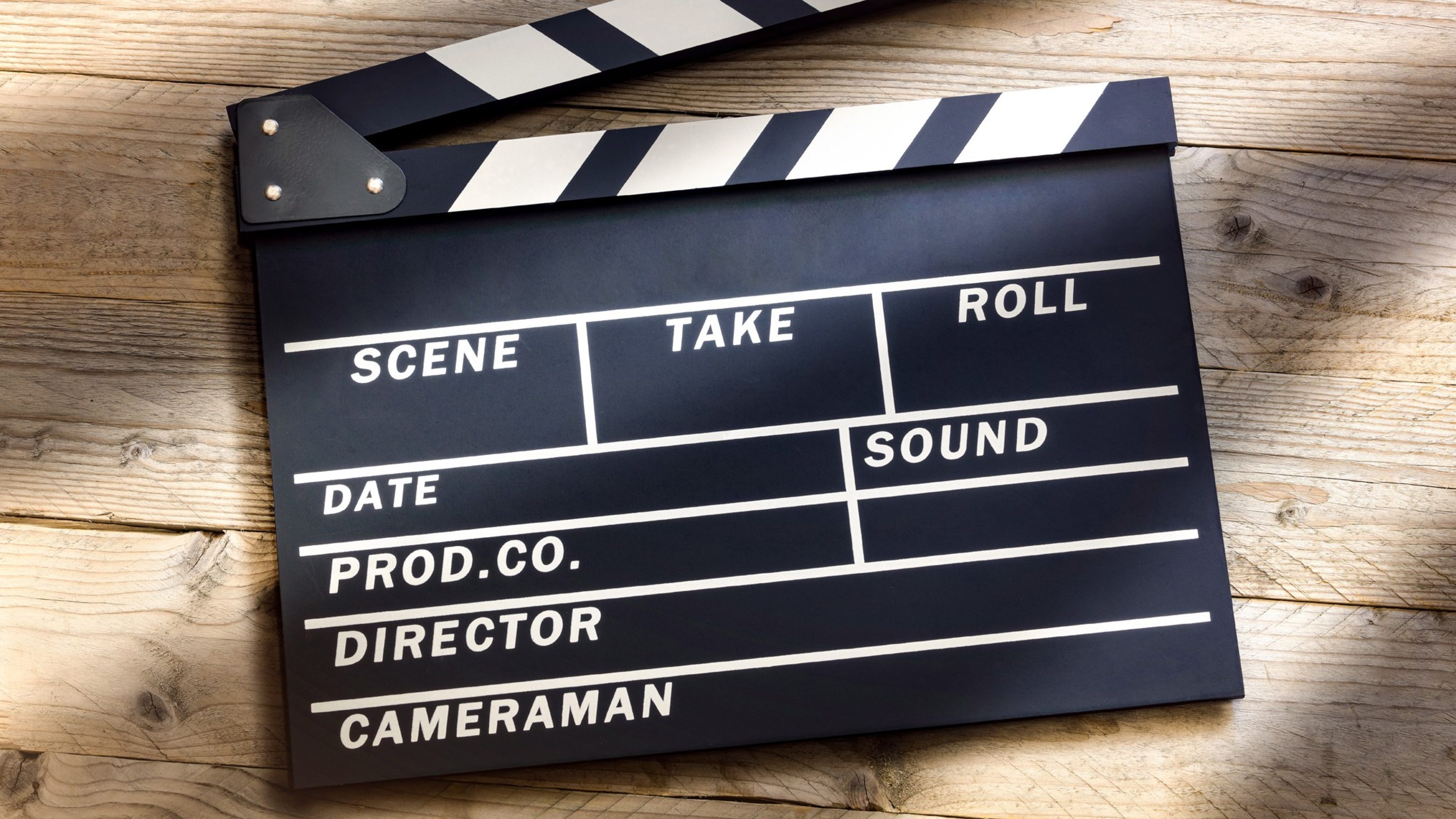 Film slate or movie clapper board on wood background