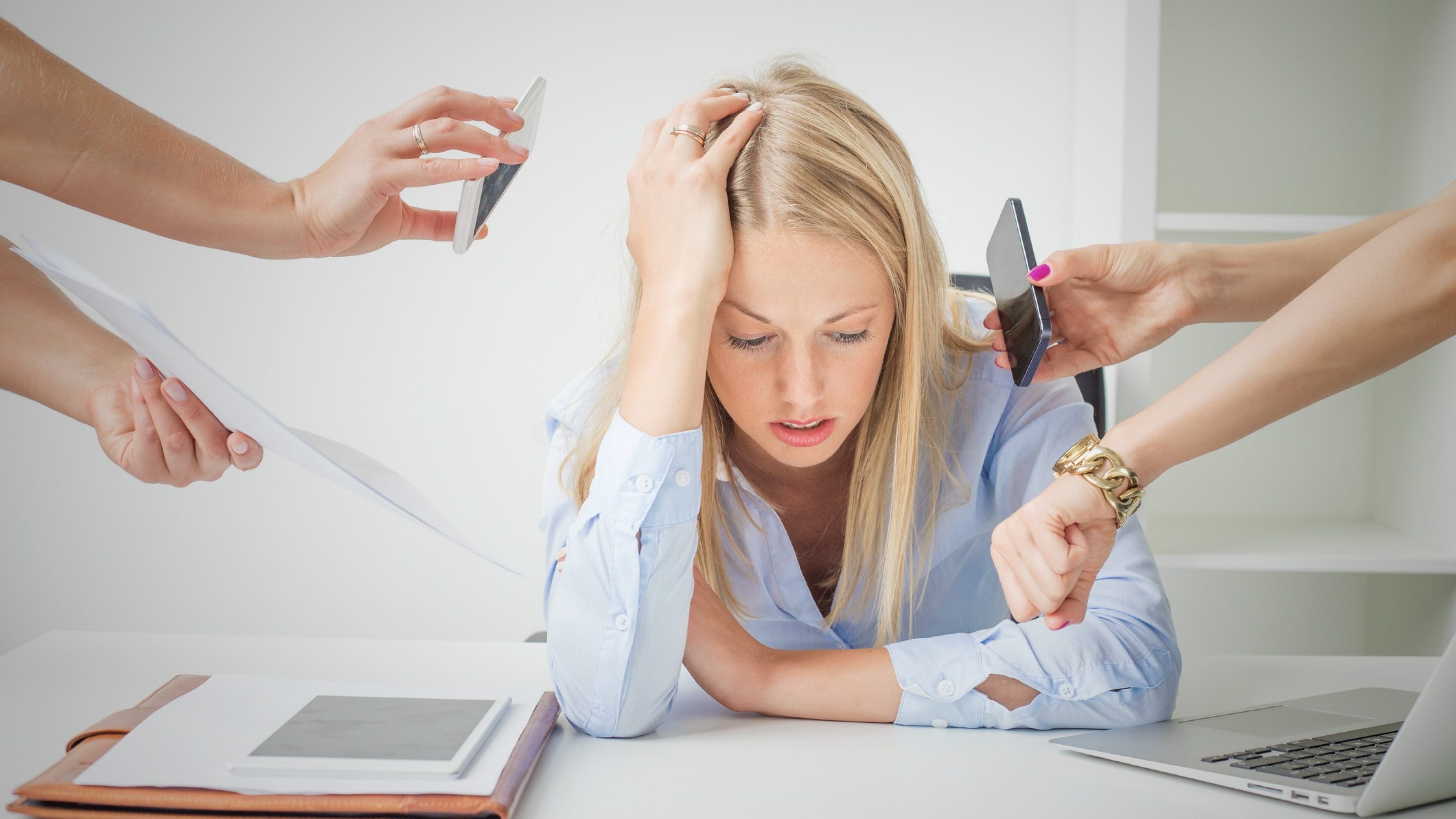 Work issues: woman overloaded with stuff at work