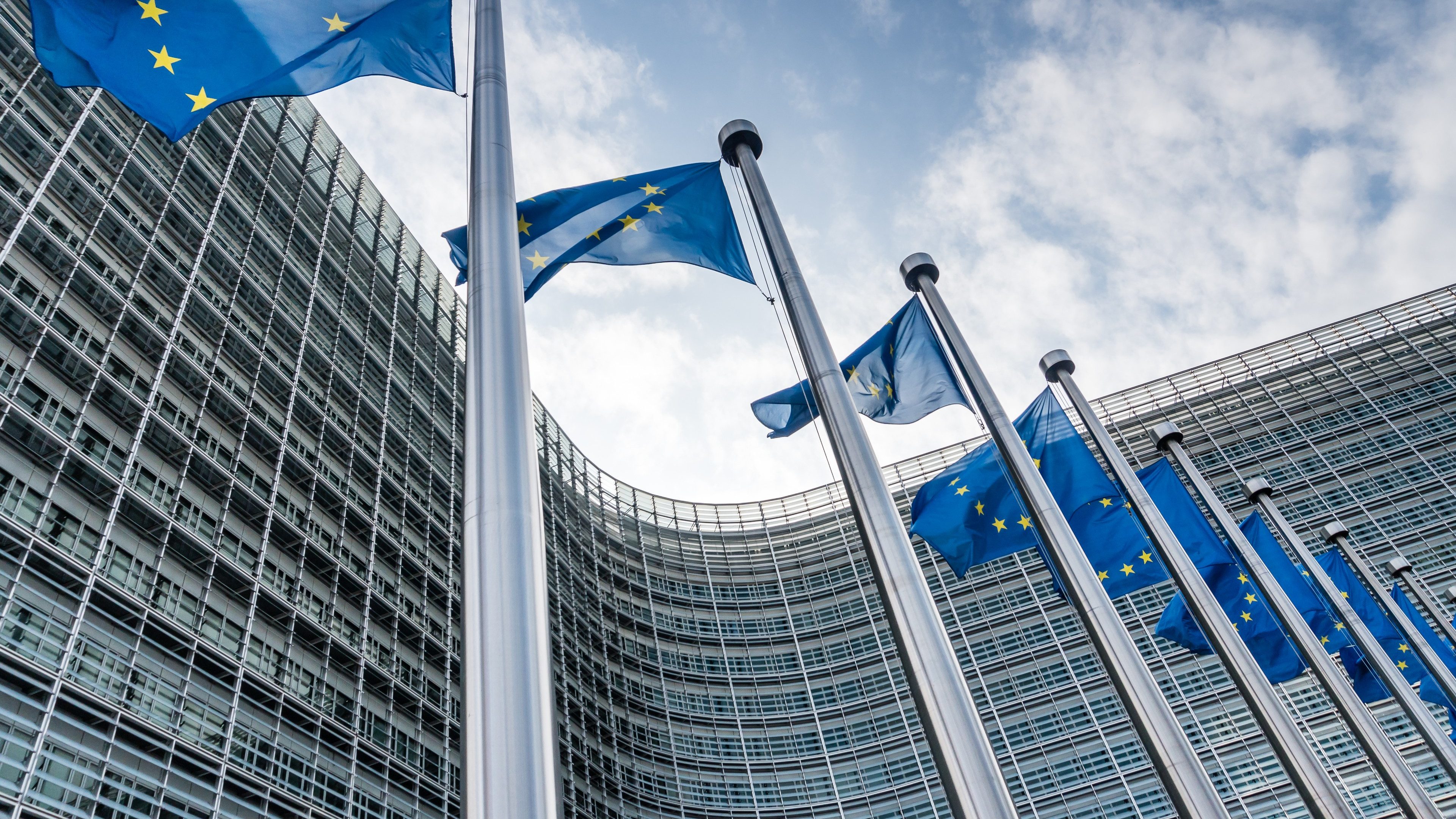 European Union flags waiving at Berlaymont building of the European Commission in Brussels, Belgium