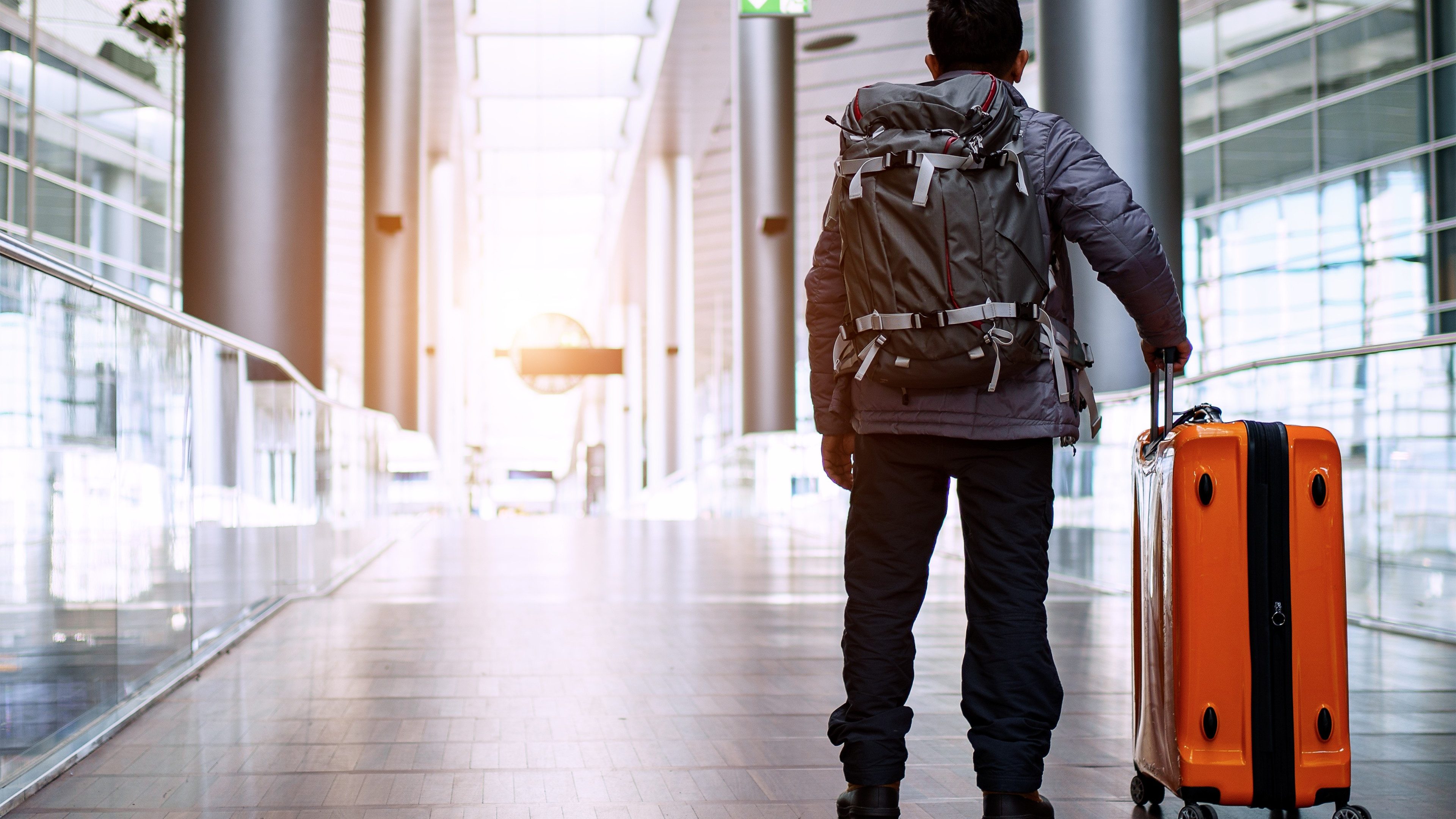 Traveler with suitcase in airport concept