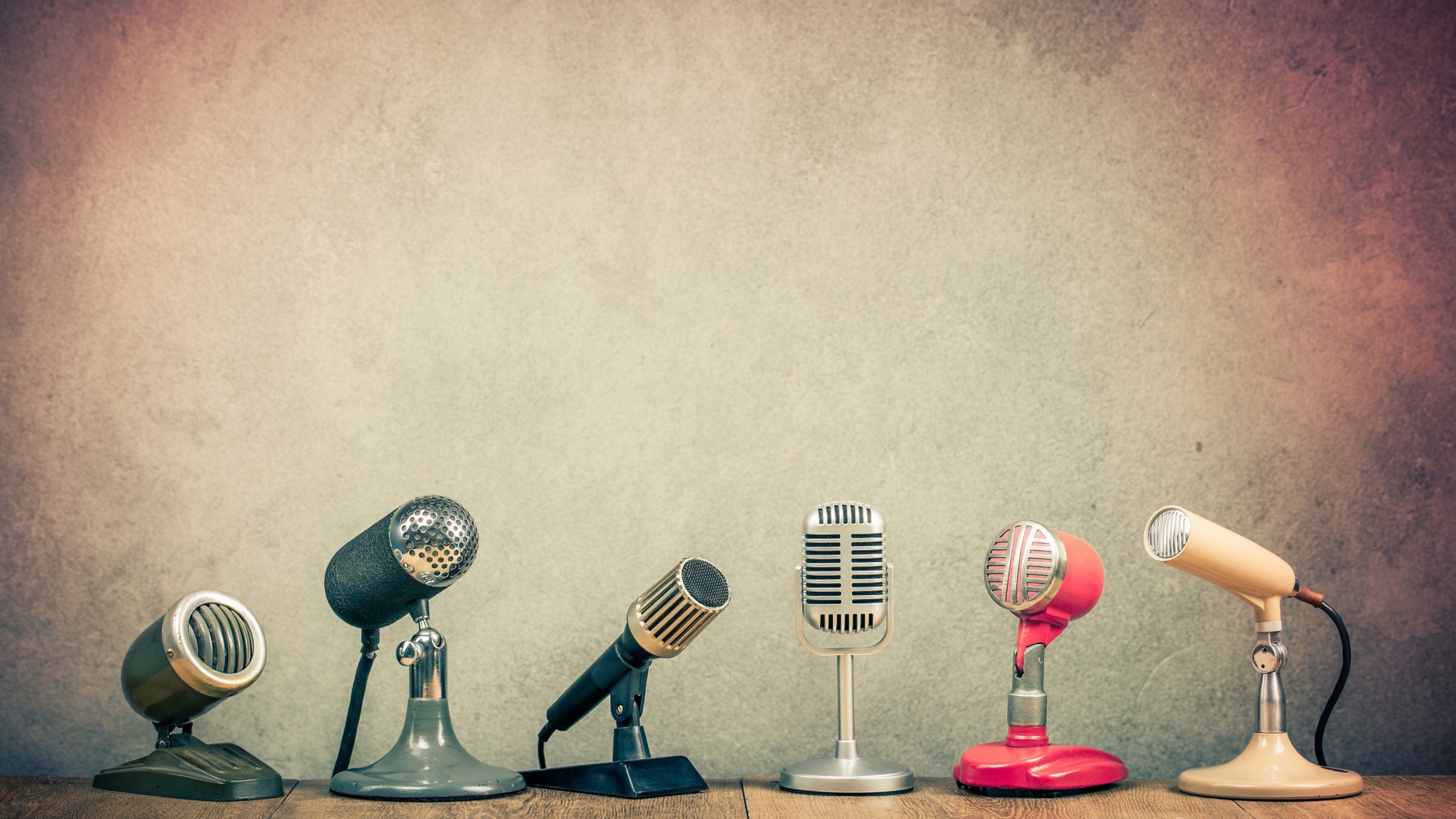 Retro old microphones for press conference or interview on wooden desk. Vintage instagram style filtered photo